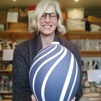 Potter Georgie Gardiner holding a large blue and white pot