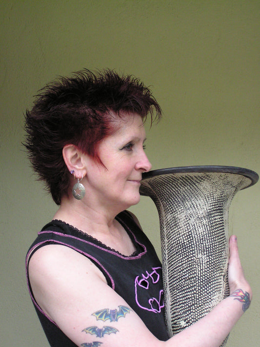 Potter Lesley McShea holding a large vase