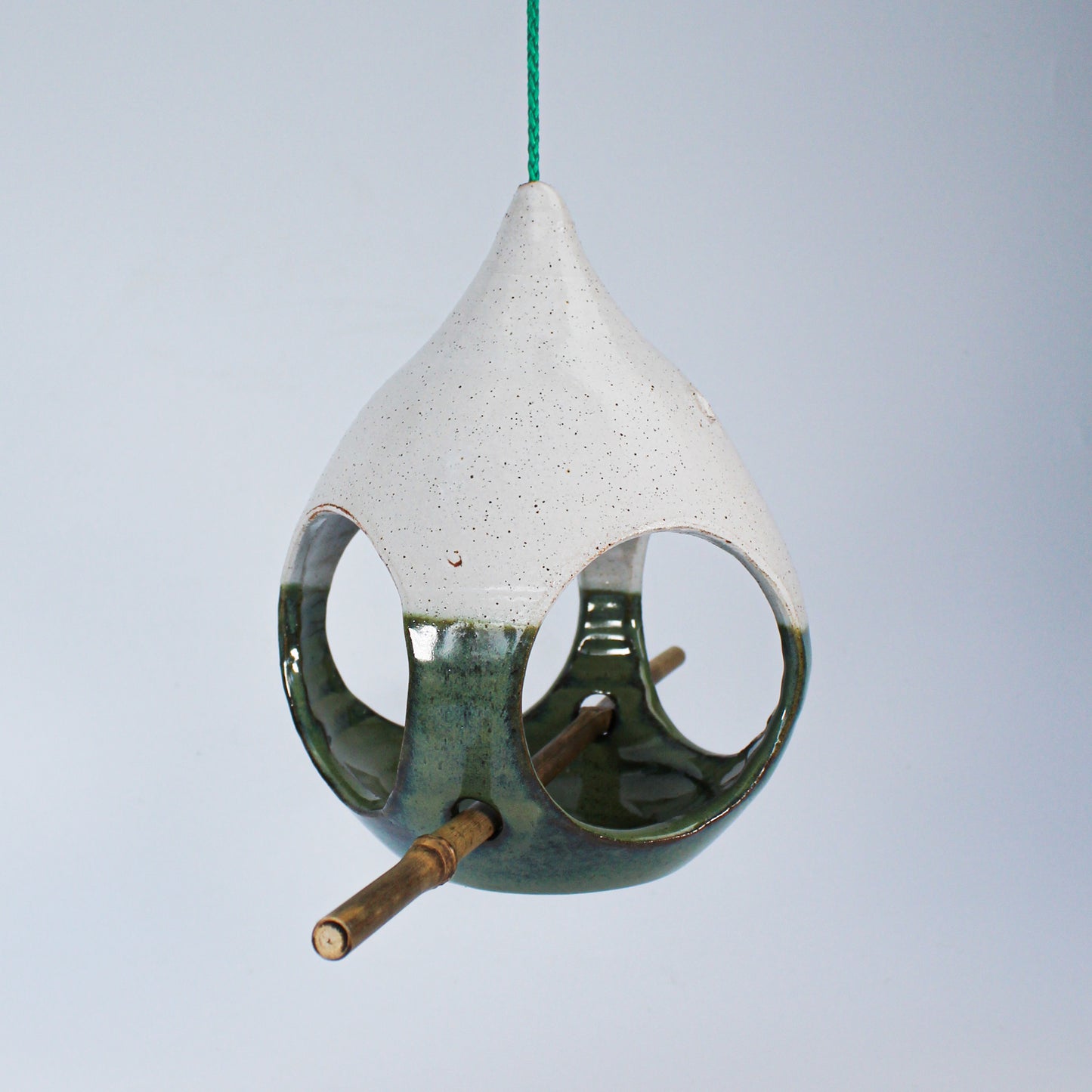 Hanging green and white ceramic bird feeder with bamboo perch 